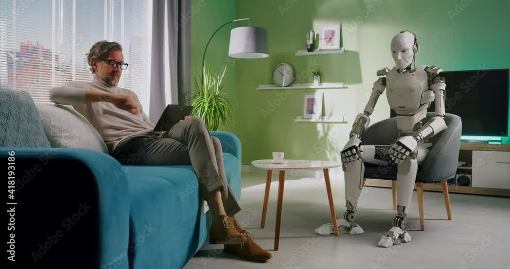 Mature man controlling robot at home