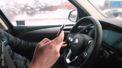 Wallpaper Mural Using a mobile phone while driving. The driver drives the vehicle, the road is moving outside the window. Manager's multitasking. Torontodigital.ca