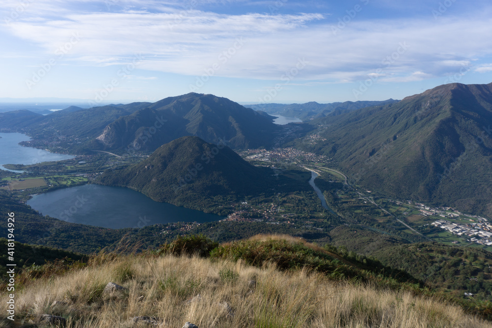 Lake maggiore and lake mergozzo seen from the mountains of val d'ossola during a summer day, near the town of Mergozzo, italy - September 2020. Lake maggiore and lake mergozzo seen from the mountains of val d'ossola during a summer day, near the town of Mergozzo, italy - September 2020.