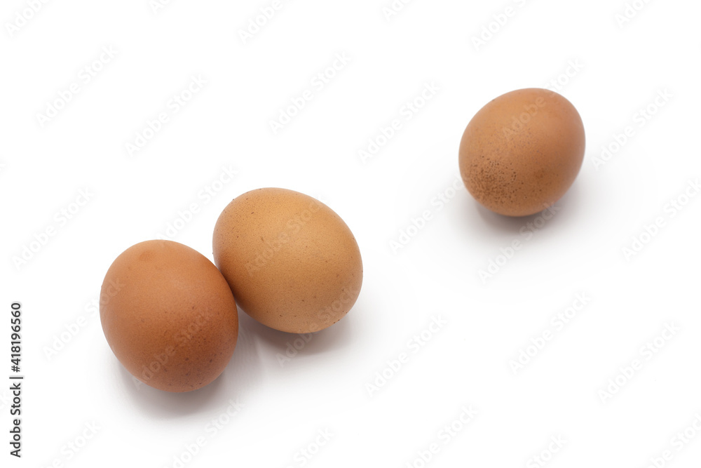 Three eggs together isolated on white background. Farm, Grocery, ecological healthy food concept. Selective focus in foreground Three eggs together isolated on white background. Farm, Grocery, ecological healthy food concept. Selective focus in foreground