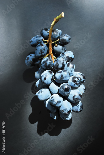 A bunch of grapes on a black background.