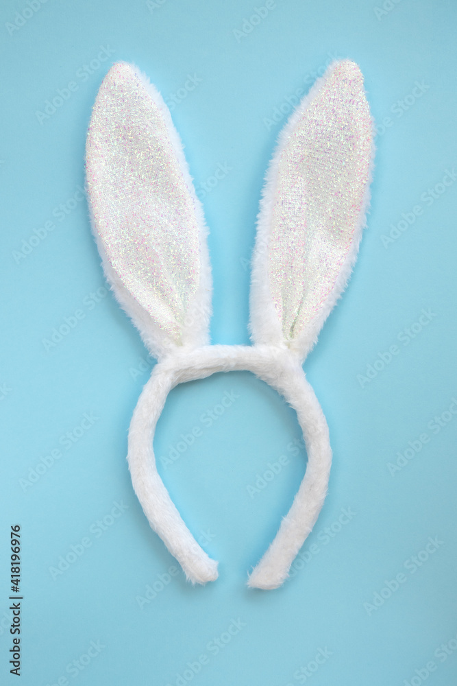 Fluffy bunny ears isolated on blue background, top view, flat lay. Fluffy bunny ears isolated on blue background, top view, flat lay.