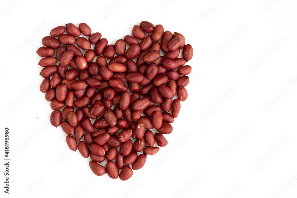 Peanuts in heart shape isolated on a white background. Valentine's day. Symbol of lovers. Peanuts in heart shape isolated on a white background. Valentine's day. Symbol of lovers.