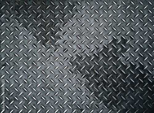 Vintage background of metal diamond plate in a gray silver color. Top view, copy space.
