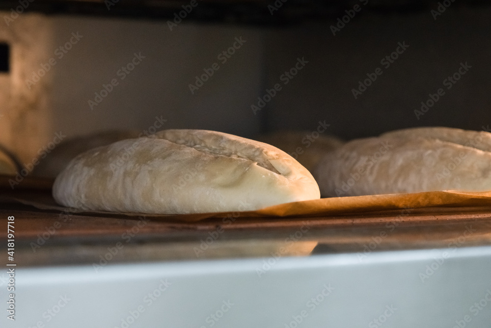 Baker making bread , man hands , kneading a dough , cooking coat.The concept of small bakeries, craft traditional bread Baker making bread , man hands , kneading a dough , cooking coat.The concept of small bakeries, craft traditional bread