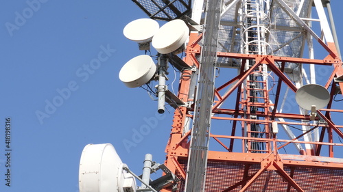 Telecommunication Cellular Tower Against Blue Sky.