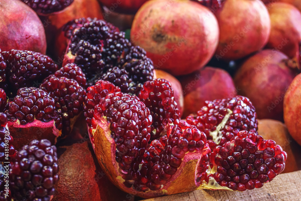 Ripe juicy pomegranates, peeled from the skin, are on display in the shopping mall. Ripe juicy pomegranates, peeled from the skin, are on display in the shopping mall.