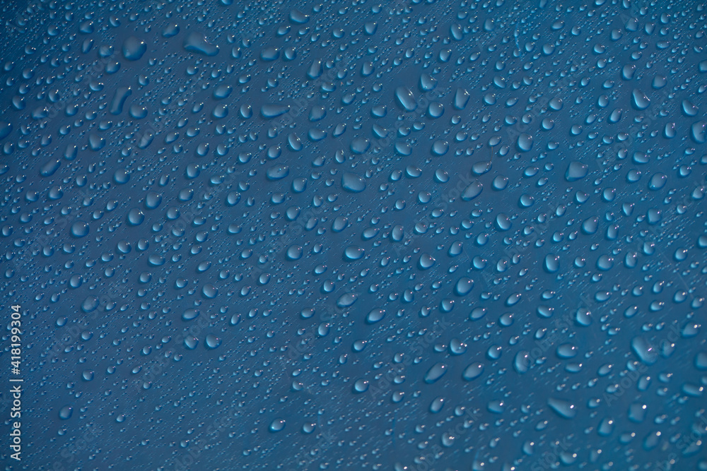 Drop dew texture. Wet water droplet on blue glass background. Bubble pattern. Drop dew texture. Wet water droplet on blue glass background. Bubble pattern.
