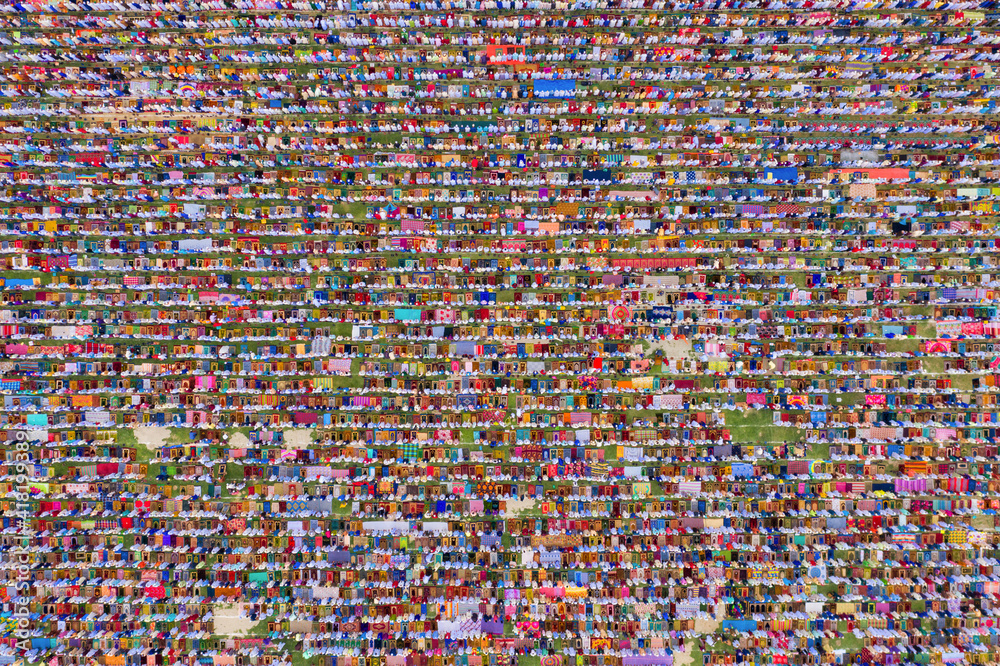 Aerial view of a vast crowd of people worshipping at Gore Shahid park in front of Eid Gah Minar religious site in Dinajpur, Rangpur, Bangladesh. Aerial view of a vast crowd of people worshipping at Gore Shahid park in front of Eid Gah Minar religious site in Dinajpur, Rangpur, Bangladesh.
