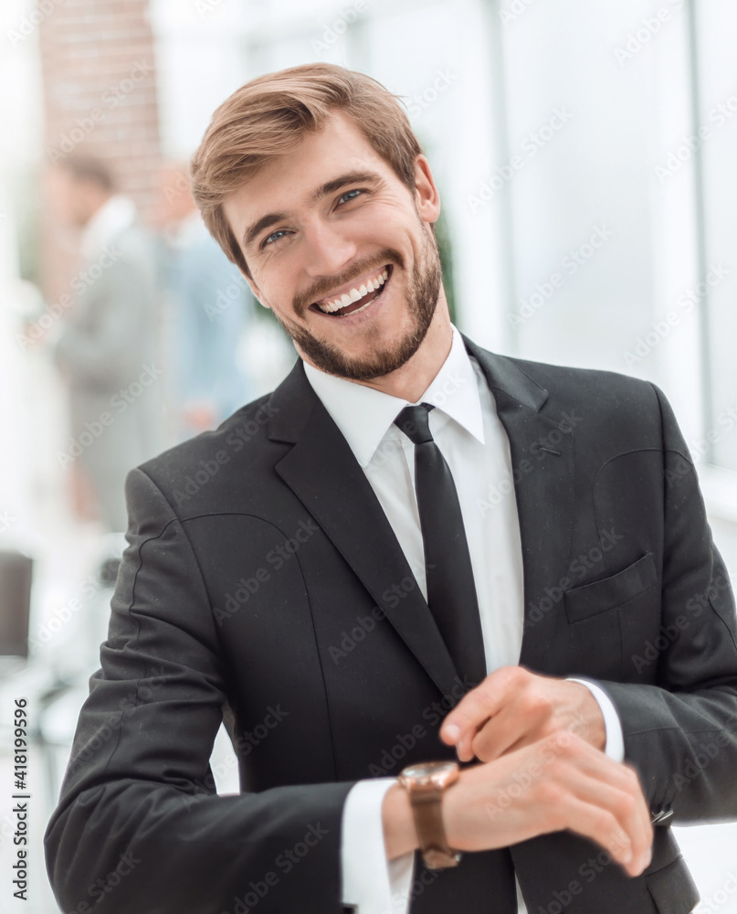 smiling businessman pointing to his wrist watch. smiling businessman pointing to his wrist watch.