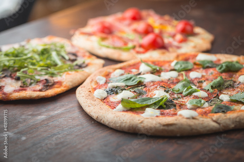Home made pizza on dark wooden background