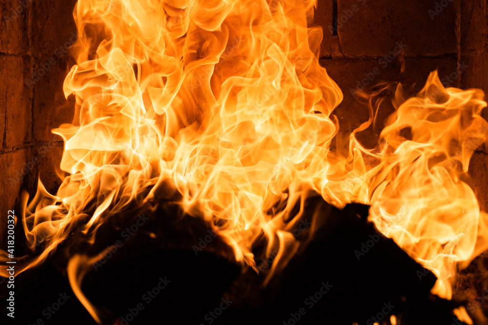 Burning cozy fire with logs. Glowing fireplace. Fire texture. Flame background. Abstract flames. Burning wood. Burning cozy fire with logs. Glowing fireplace. Fire texture. Flame background. Abstract flames. Burning wood.