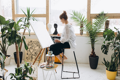 Creative woman painting on canvas with brush