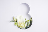 Number 8 with fresh gerbera, calla and rose flowers with green leaves on bright white background. Minimal Women's day, March 8th or birthday concept. Flat lay, top view.