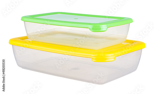 Two empty different size transparent plastic food containers with colored lids in stack isolated on white background