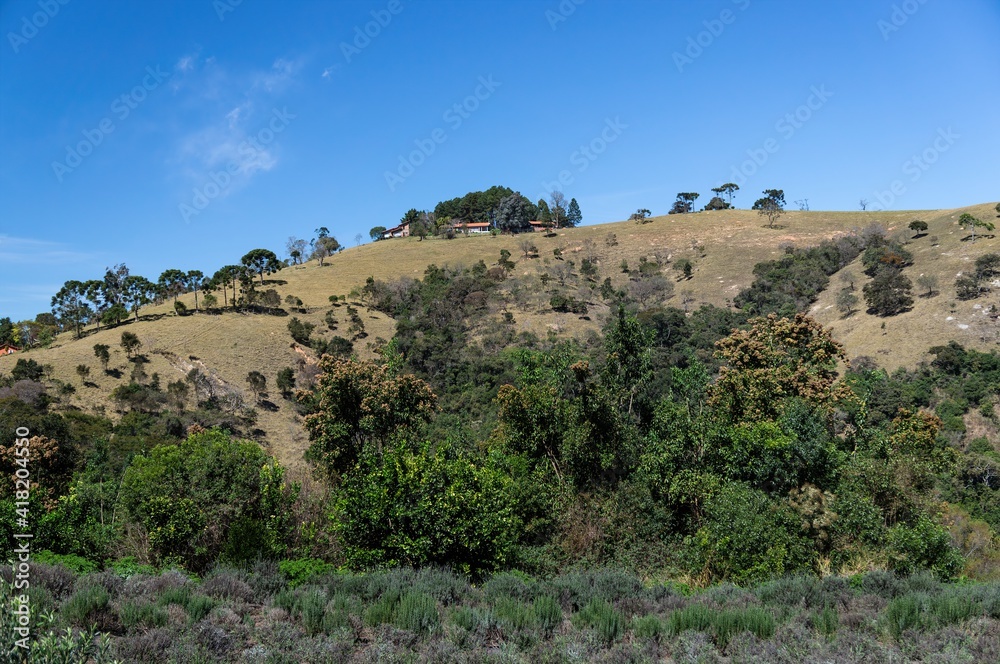 A big mountain nearby with some houses on top saw from 