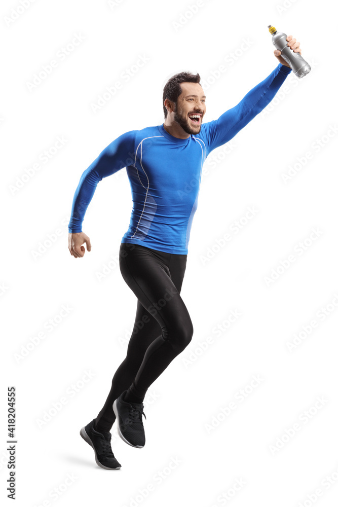 Full length shot of a fit man in sportswear running and holding a bottle with drink Full length shot of a fit man in sportswear running and holding a bottle with drink