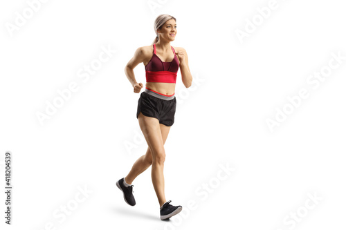 Full length shot of a blond young female in sportswear running