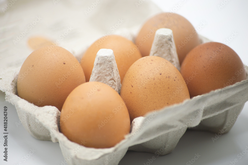 Close up view filled egg carton or recyclable box on white background. Horizontal shot Close up view filled egg carton or recyclable box on white background. Horizontal shot