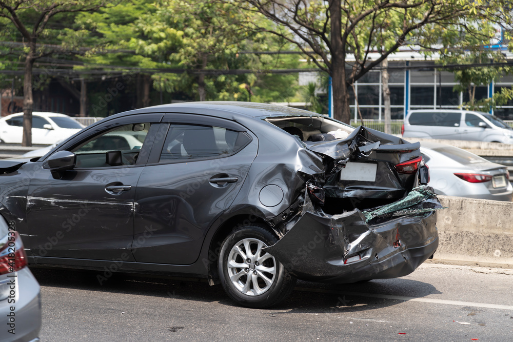 Black car get damaged by accident on the road. concept of road safety. Black car get damaged by accident on the road. concept of road safety.