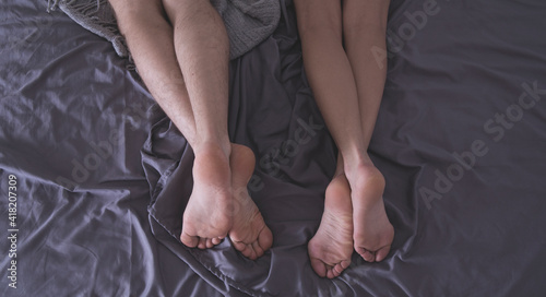 Sexy couple. Beautiful couple lying together on the bed. Sexy photo. Sex. Legs. 