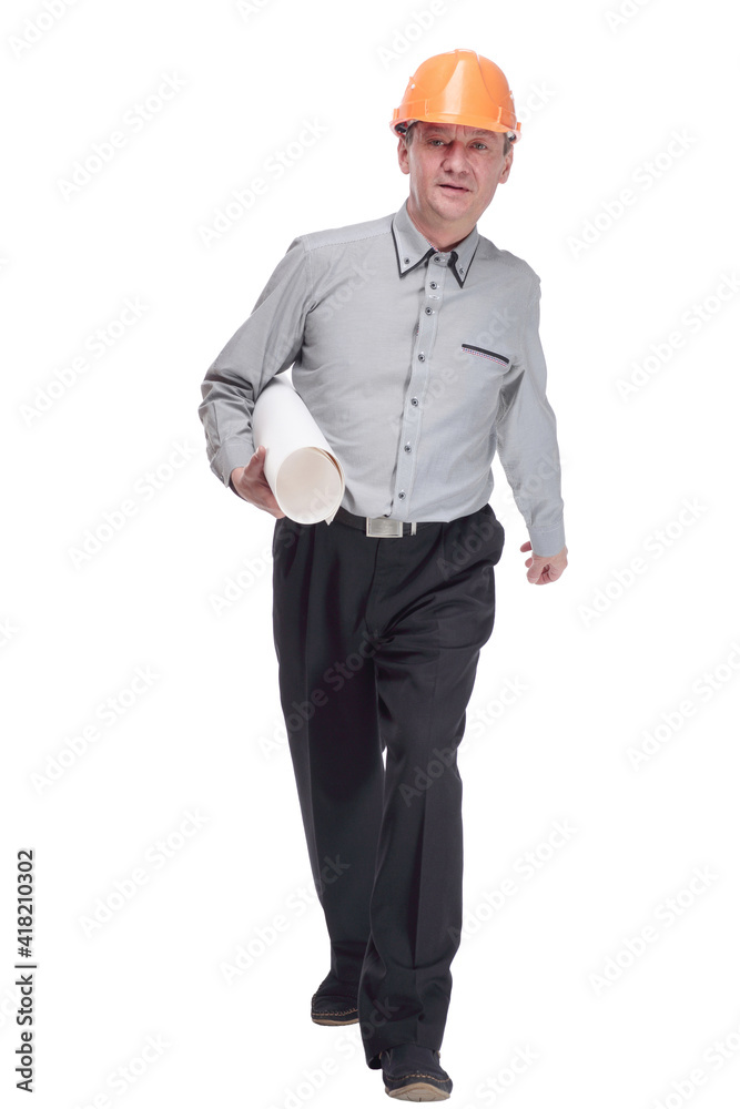 man in a protective helmet with a roll of blueprints striding forward . man in a protective helmet with a roll of blueprints striding forward .
