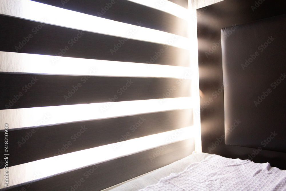 Fototapeta premium room with gray window blinds getting sunlight