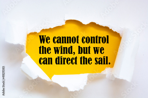 Inspirational motivational quote. We cannot control the wind, but we can direct the sail. photo