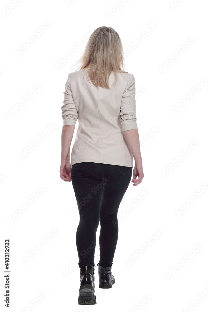 woman in a white jacket striding confidently away . woman in a white jacket striding confidently away .