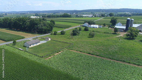 Aerial View of an Amish One Room School House in the Middle Of Amish Farmlands on a Sunny Day