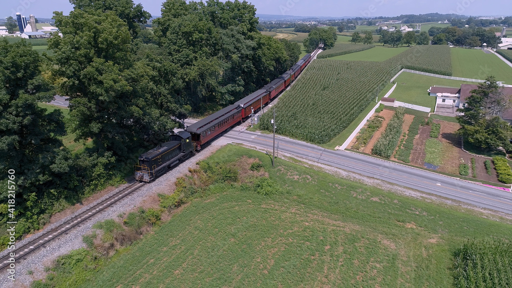 Aerial View of An Antique Restored Diesel Locomotive Traveling Thru Farmlands and Countryside on a Sunny Summer Day