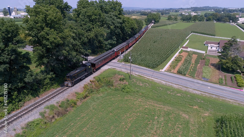 Aerial View of An Antique Restored Diesel Locomotive Traveling Thru Farmlands and Countryside on a Sunny Summer Day