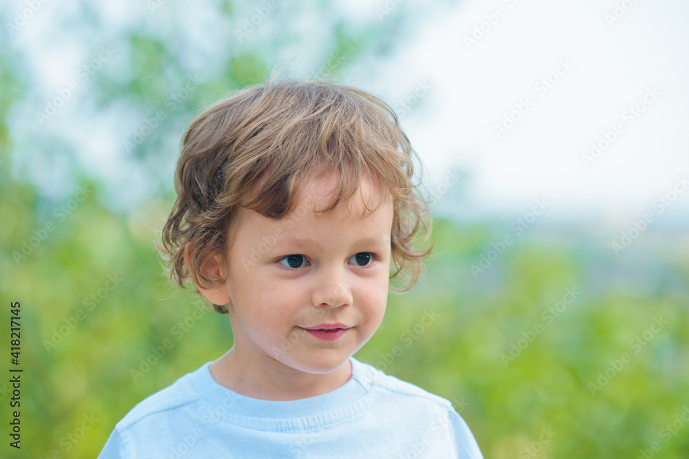 Portrait of a happy kid smiling and having fun. Happy little boy. Emotional portrait of a little boy on a walk in a city park. Happy child in summer in nature. Child play outdoors. Portrait of a happy kid smiling and having fun. Happy little boy. Emotional portrait of a little boy on a walk in a city park. Happy child in summer in nature. Child play outdoors.
