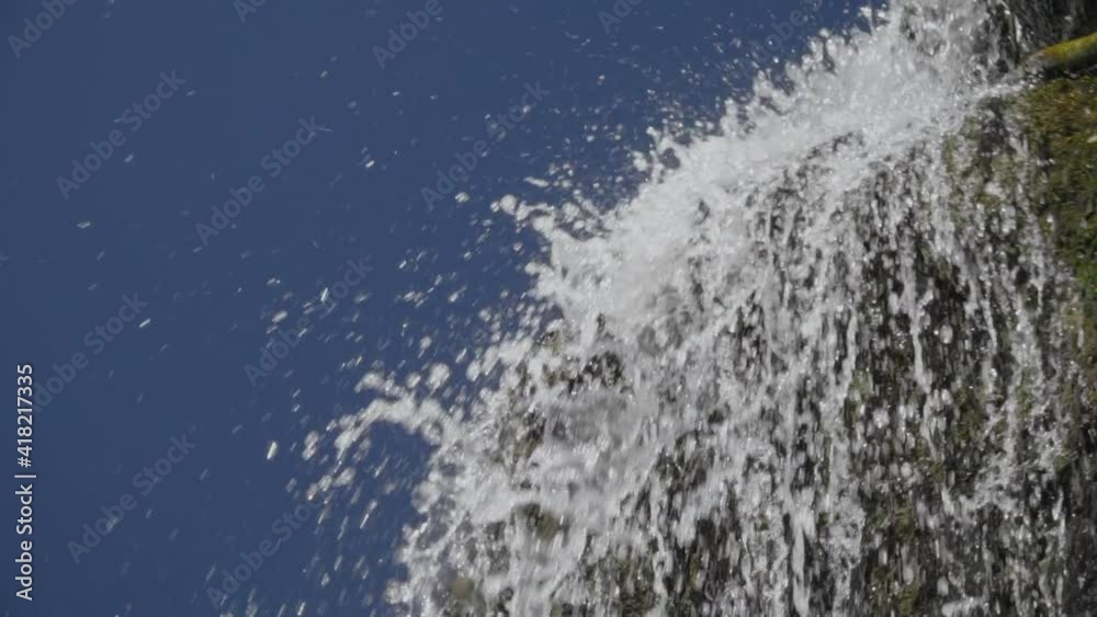 Slow Motion, Splashes From Mountain Falls Fall Down Against The Face of Blue Sky Slow Motion, Splashes From Mountain Falls Fall Down Against The Face of Blue Sky