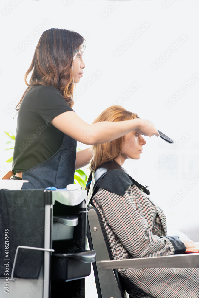 Hairdressers, working in salons with COVID19 safety measures, are