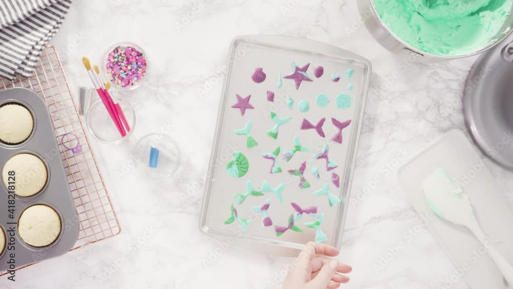 Time lapse. Flat lay. Step by step. Mixing ingredients in kitchen mixer to make buttercream frosting for mermaid theme vanilla cupcakes. Time lapse. Flat lay. Step by step. Mixing ingredients in kitchen mixer to make buttercream frosting for mermaid theme vanilla cupcakes.