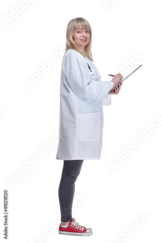 young female doctor making notes in a clipboard .