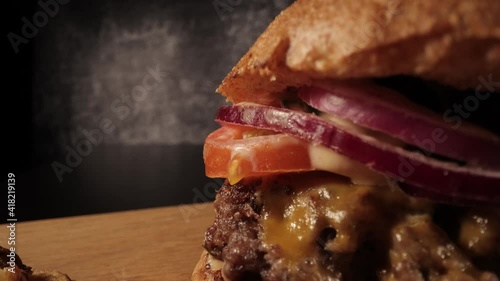 Extreme close-up of a fresh made burger - Chesseburger - food photography photo