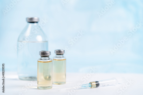 vaccine and syringe, medical masks on a white background, covid 19