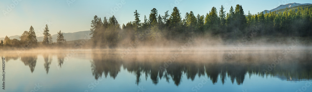 Panoramic view of forest lake in morning fog, summer travel Panoramic view of forest lake in morning fog, summer travel