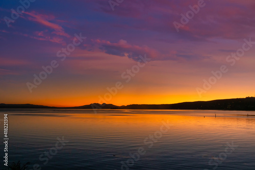 Mount Ngauruhoe and Ruapehu volcanic mountains in the distance as sunset turns to night viewed from Lake Taupo © Stewart