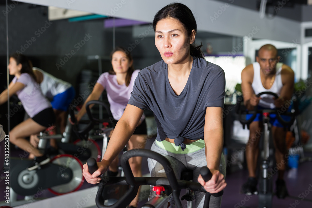 Woman and other females working out in sport club