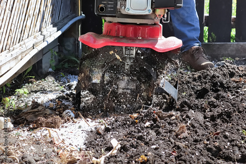 Wallpaper Mural Cultivating garden soil in the spring with a rototiller Torontodigital.ca