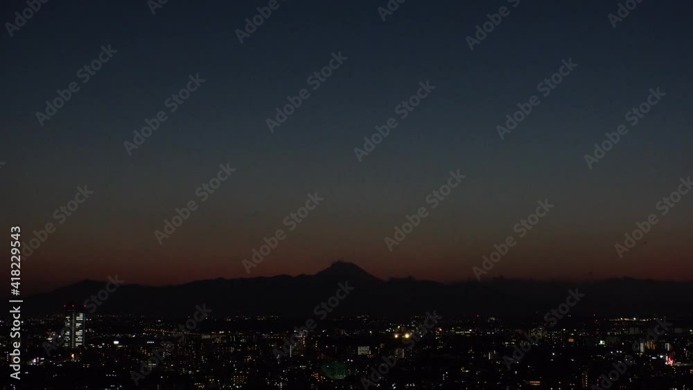 TOKYO, JAPAN : Aerial sunrise CITYSCAPE of TOKYO and MOUNT FUJI. View of rising sun, dawn sky and buildings. Japanese city life and nature concept. Time lapse zoom in video, night to early morning. TOKYO, JAPAN : Aerial sunrise CITYSCAPE of TOKYO and MOUNT FUJI. View of rising sun, dawn sky and buildings. Japanese city life and nature concept. Time lapse zoom in video, night to early morning.