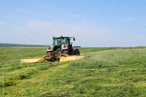 Tractor Mow Grass On A Meadow