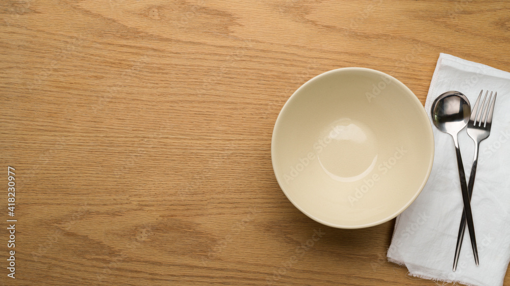 Table Setting Background, mock up ceramic bowl, fork and spoon on white napkin, clean bowl Table Setting Background, mock up ceramic bowl, fork and spoon on white napkin, clean bowl