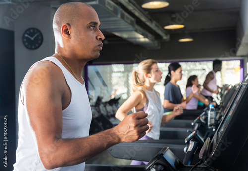 Man running on a treadmill in a sports club