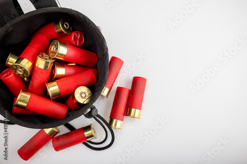 Black bag and shotgun shell ammunition for practicing sports on white background