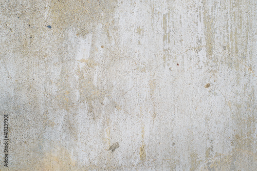 Texture of old gray concrete wall outside, close-up. Faded white paint, scratches, damage. Rough background, copy space
