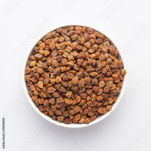 Close up of Organic chana or chickpea (Cicer arietinum) or whole white Bengal gram dal on a ceramic white bowl. Top view 